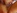 Une brune aux seins silicons se fait juter dans la bouche