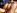 Une brune aux seins silicons se fait juter dans la bouche